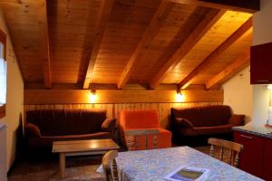 a living room with two chairs and a table at Chalet Presanella in Temù