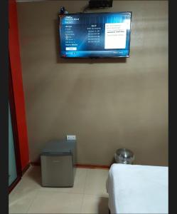 a room with a flat screen tv on the wall at SMART INN GUEST HOUSE in Jwaneng