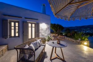 a patio with a couch and a table at Villa Spitaki in Aliki