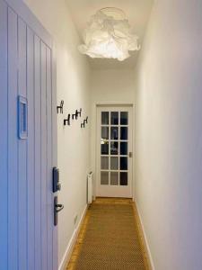 a hallway with a door and a ceiling with birds on the wall at 21 Melbourne Place Studios in St Andrews