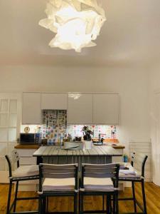 a kitchen with a table and two chairs and a chandelier at 21 Melbourne Place Studios in St Andrews