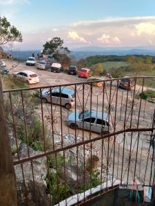 a view of a parking lot with cars parked at Hospedaria Piramide Por Do Sol in São Thomé das Letras