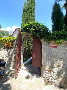 an entrance to a stone building with an open door at Guest House Kiparis in Miskhor