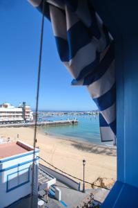 a view of a beach and the ocean from a building at AVANTI Lifestyle Hotel - Only Adults in Corralejo
