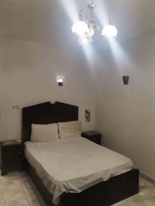 a bedroom with a bed with lights on the ceiling at Mama Africa in Hurghada