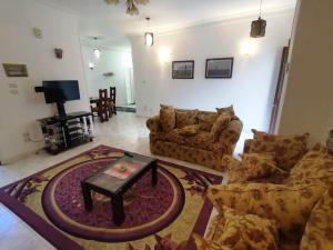 a living room with two couches and a table at Mama Africa in Hurghada