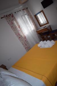 尼歐克利馬的住宿－Mariren，一间卧室设有一张黄色的大床和一扇窗户。