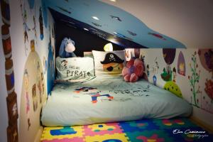 a bedroom with a bed with a surfboard on it at Le Fenil Aux Ânes in Walcourt