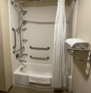 a bathroom with a shower and a bath tub at Wingate by Wyndham Pittsburgh West Mifflin in West Mifflin