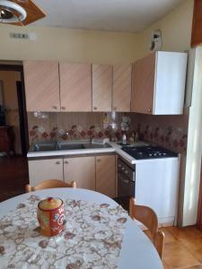 a kitchen with a table and a stove and a sink at Casa Gravere bis in Gravere