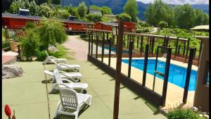 a group of lounge chairs next to a swimming pool at Descanso de las Piedras in Tafí del Valle