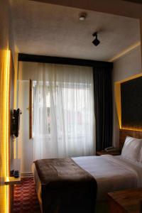 a hotel room with a bed and a window at ESKOPPremium OTEL in Bolu