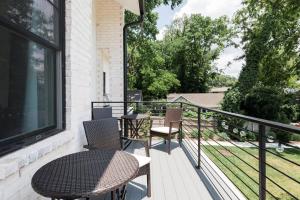 a balcony with two chairs and a table and a window at Brand New Luxury Home near Downtown in Nashville