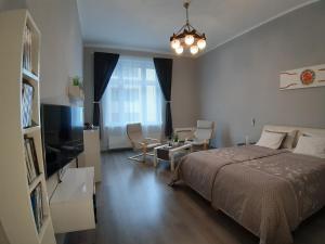 a bedroom with a bed and a living room at Central Apartment Budapest in Budapest