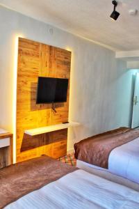a hotel room with two beds and a flat screen tv at ESKOPPremium OTEL in Bolu