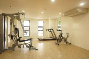 a gym with two treadmills and two exercise bikes at Cebu City Apartment - Mabolo Gardens in Cebu City