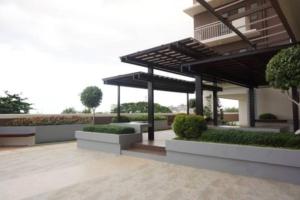 a pavilion in a courtyard with bushes and trees at Cebu City Apartment - Mabolo Gardens in Cebu City