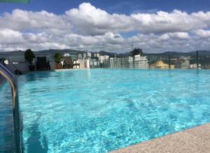 a large swimming pool on the roof of a building at Cebu City Apartment - Mabolo Gardens in Cebu City +9 photos