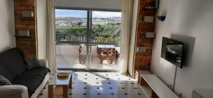 een woonkamer met een bank en een groot raam bij Apartment Riviera del Sol - Seaview in Mijas Costa