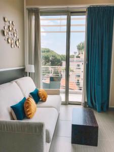a living room with a couch and a large window at The One Hotel - Designed for Adults - Pet lovers in Riccione