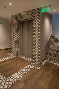 an elevator in a building with a tile wall at Residencial & Hotel Palazzo in Panama City