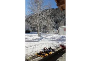 a group of people on a snowmobile in the snow at Chalet Presanella in Temù