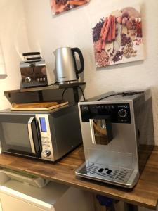 a counter with a microwave and a toaster oven on it at Apartment Essen Holsterhausen in Essen +17 photos