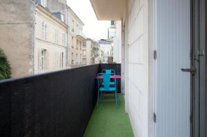 a blue chair sitting on the side of a balcony at Edouard Grimaux in Poitiers