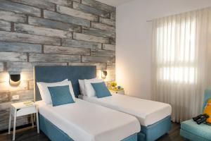 Postel nebo postele na pokoji v ubytování Metulla Travel Hotel
