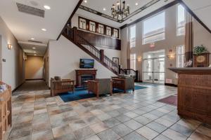 a lobby with a staircase and a living room at TownSquare Place in Chaska