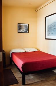 a bed in a room with a red mattress at Old Brewery Hostel in Tonopah