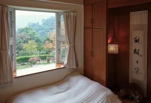 Llit o llits en una habitació de Wisdom Garden Home Stay