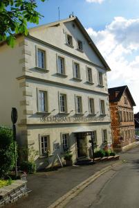 a large white building on the side of a street at Staffelsteiner Hof in Bad Staffelstein