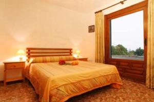 a bedroom with a bed and a large window at Holiday Home Bonestar in Jávea