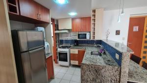 a kitchen with a sink and a stove top oven at Paraíso do Sul Recife in Recife