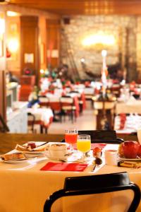 a table with two glasses of orange juice on it at Hotel Antica Fonte in Brescia