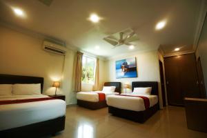 a hotel room with two beds and a ceiling fan at Tioman Dive Resort in Tioman Island +45 photos