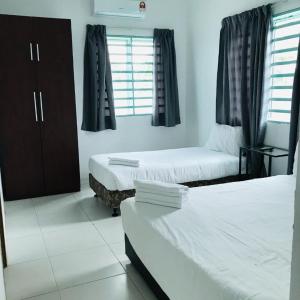 a hotel room with two beds and a window at Motel Fasa2B in Seri Manjung