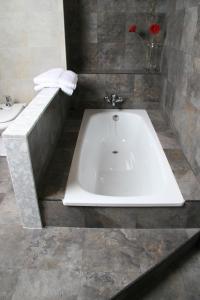 a bathroom with a bath tub and a sink at Casa Morató in Beceite