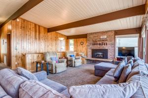 a living room with couches and a fireplace at All Ashore in Lincoln City