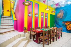 a restaurant with colorful walls and tables and chairs at CASA MARÍA MALECÓN in Puerto Vallarta