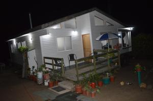 uma pequena casa branca com um alpendre à noite em CASA BLANCA SPA em Puchuncaví