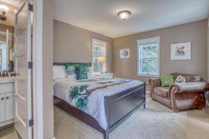 a bedroom with a large bed and a chair at Coastal Bliss in Lincoln City