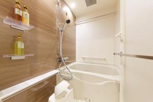 a bathroom with a shower and a sink and a tub at MONday Apart Asakusabashi Akihabara in Tokyo