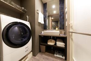 a bathroom with a washing machine and a sink at MONday Apart Asakusabashi Akihabara in Tokyo