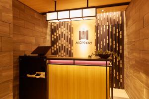 a lobby with a monkey sign on the wall at MONday Apart Asakusabashi Akihabara in Tokyo