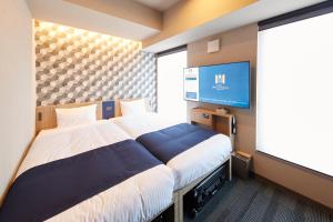 Ένα ή περισσότερα κρεβάτια σε δωμάτιο στο MONday Apart Asakusabashi Akihabara
