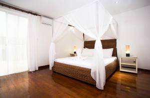 Tempat tidur dalam kamar di Mabuhay Beach House