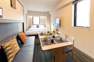 a hotel room with a table and a bed at MONday Apart Asakusabashi Akihabara in Tokyo