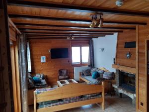 a living room with a couch and a fireplace at B&B La Seigneurie in Les Gets